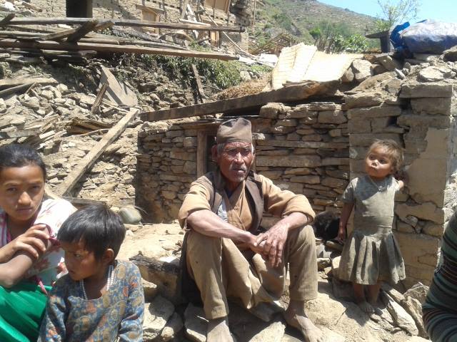 Family outside their damaged home after an earthquake